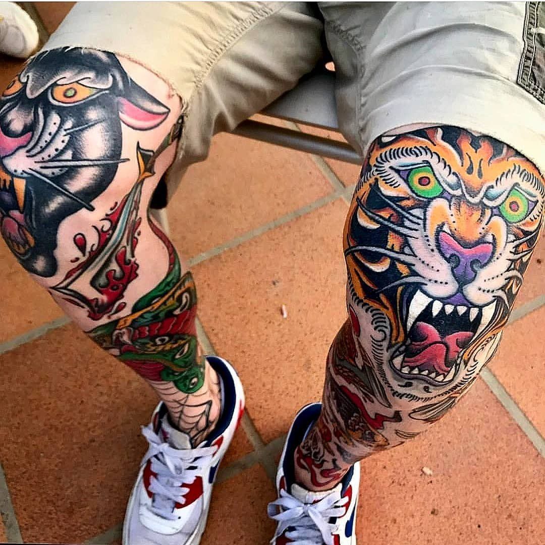 Person's legs featuring large, colorful American traditional tattoos of a panther and a tiger head.